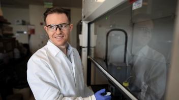 Chris Simmons, Ph.D. working in his lab on food waste byproduct.