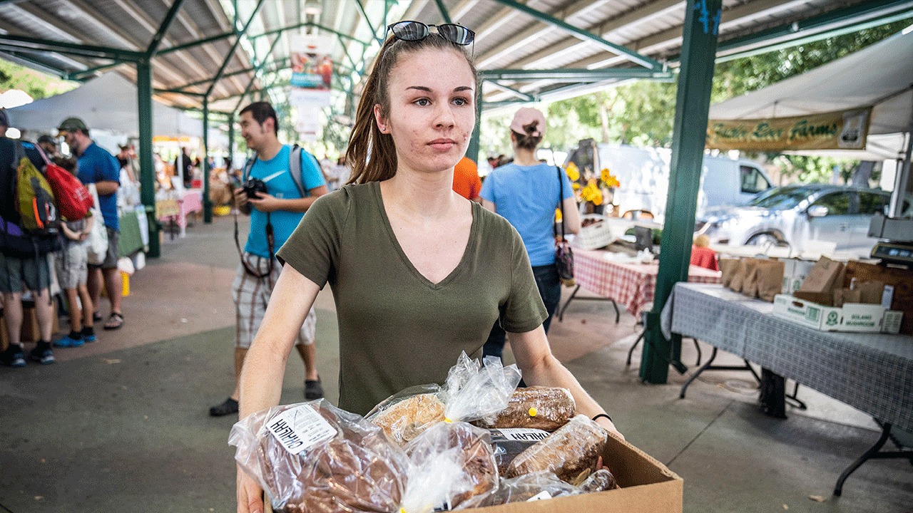 Alicia Marzolf, a Clinical Nutrition major, at the Farmers Market in Downtown Davis. The students collect food that is distributed to families by the Yolo Food Food Bank.